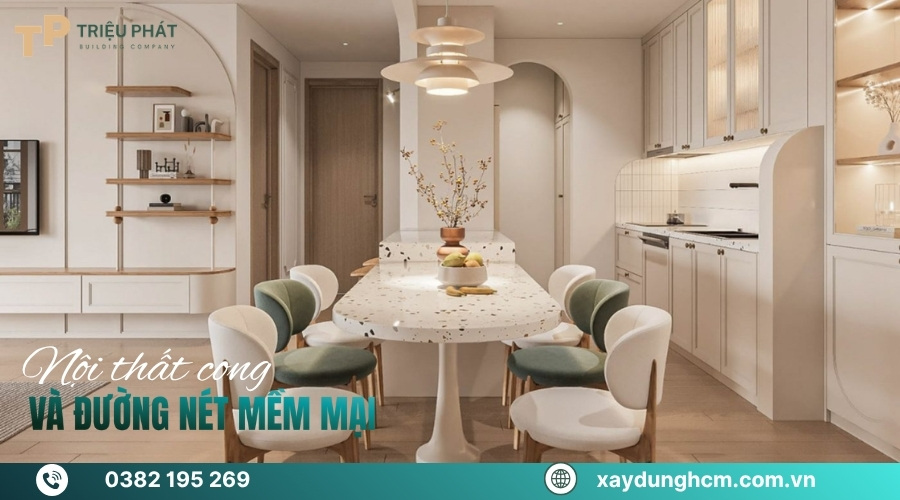 Sofa bo tròn, bàn tròn gỗ và đèn trang trí hình học mềm mại.